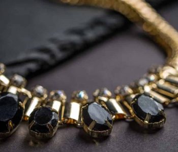 Wear a necklace made of black stones.